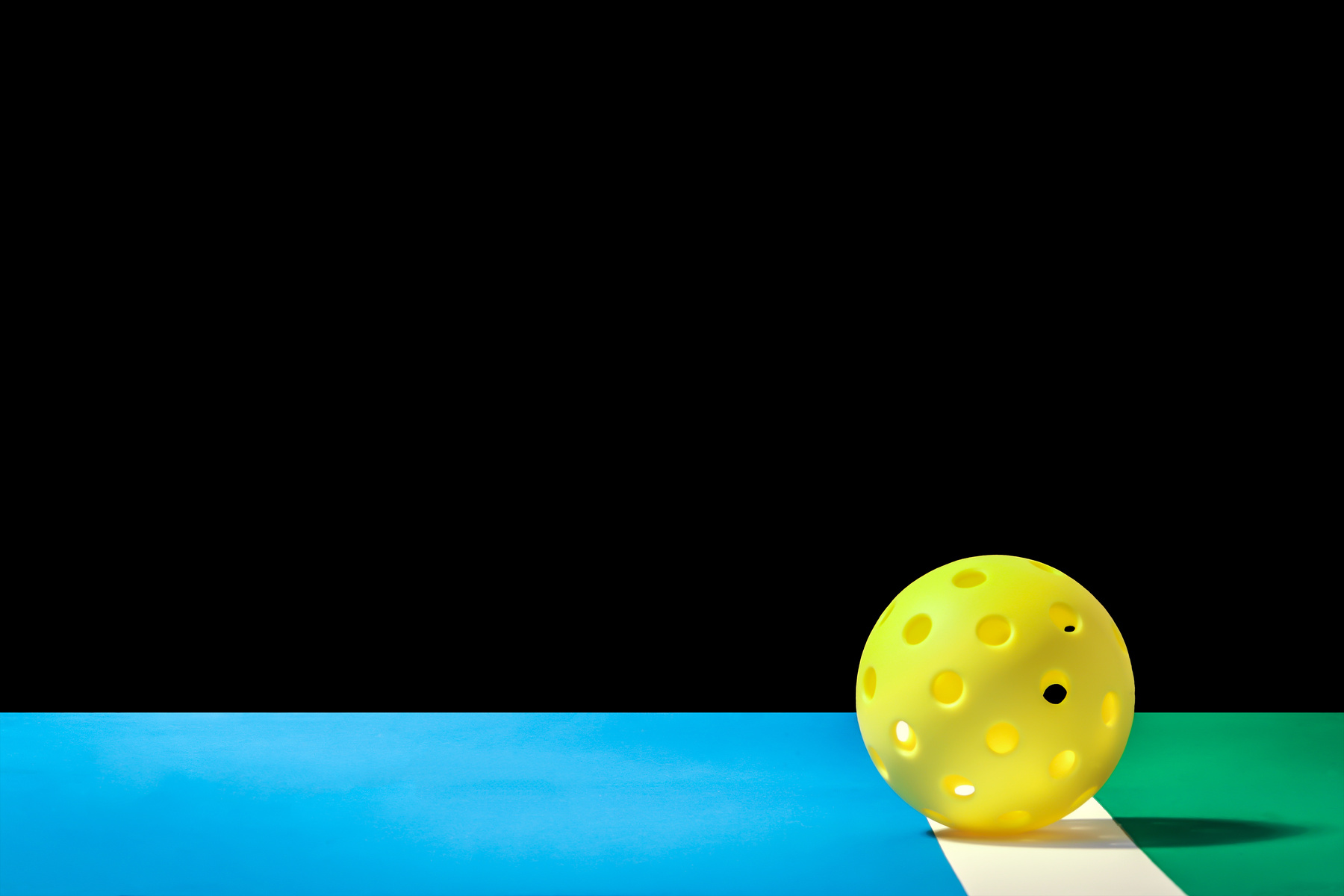 Small Yellow Pickleball with large background